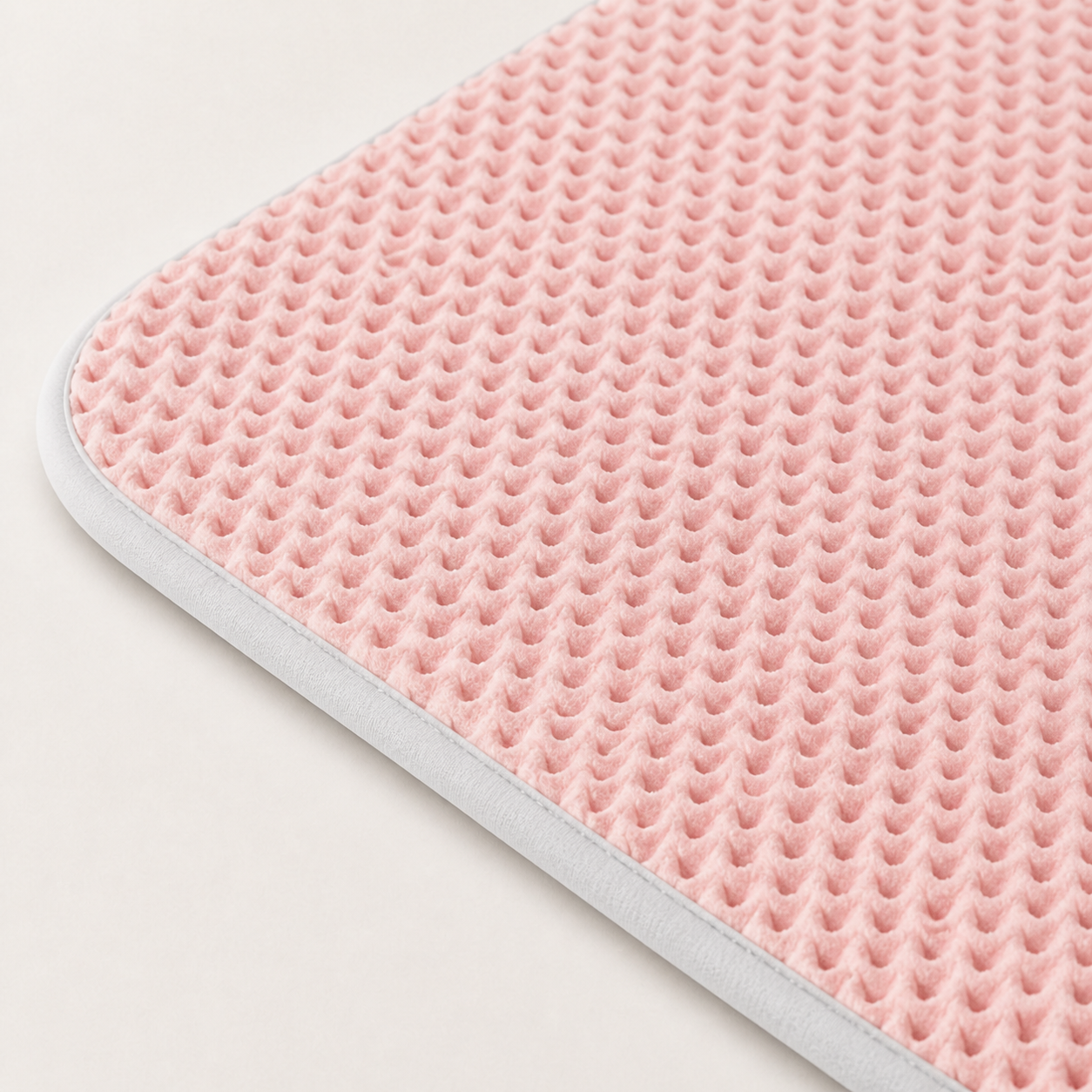 Close view of the breathable pink mat texture and bound edge