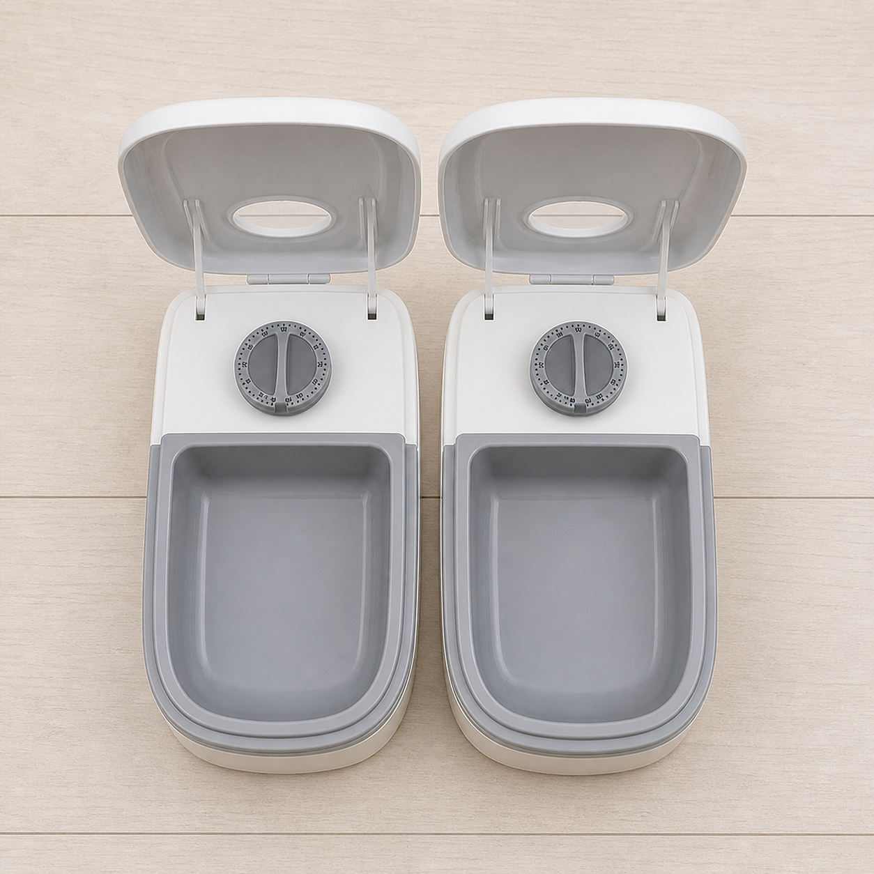 Both timed feeder lids open with empty grey trays