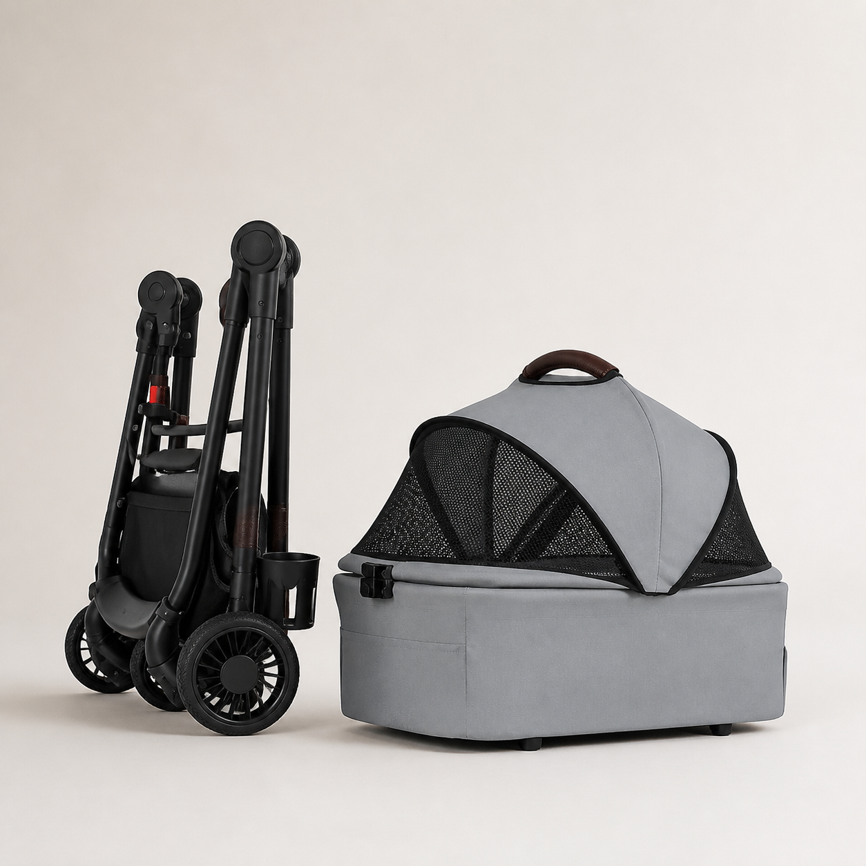 Compact folded pet stroller frame beside the removable grey carrier