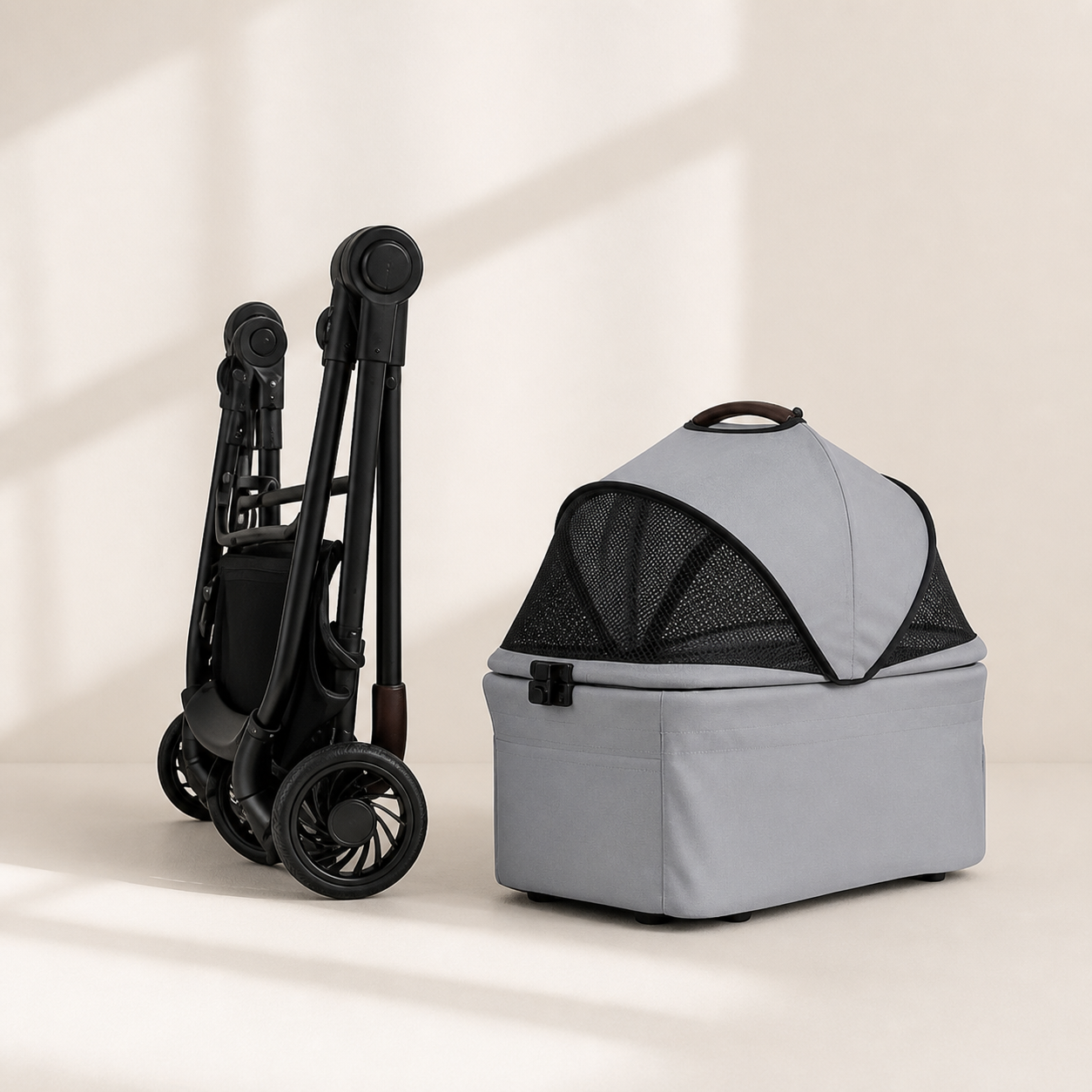 Grey removable pet carrier beside the compact folded stroller frame