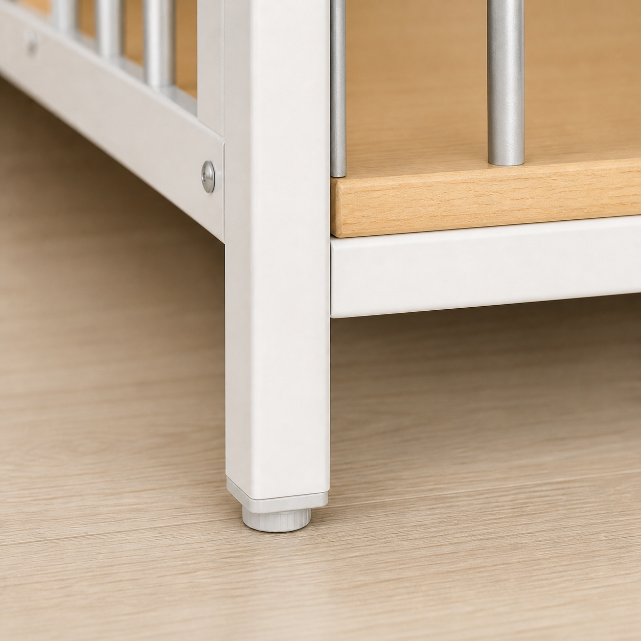Adjustable foot beneath the white crate frame