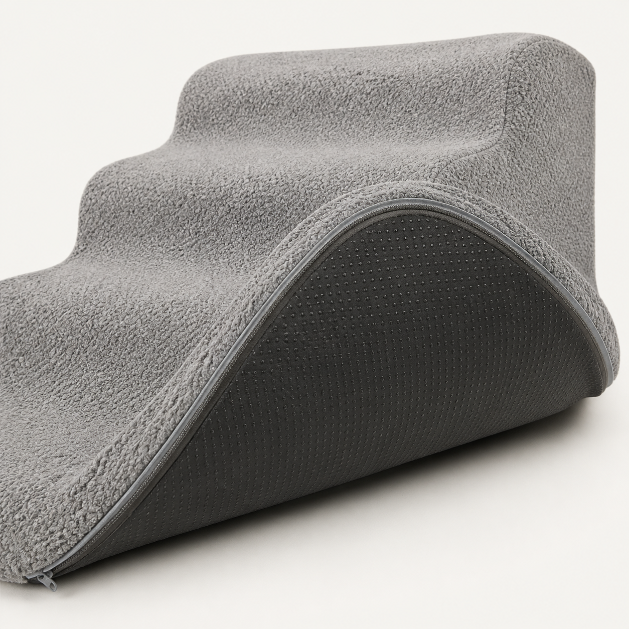 Dark non-slip base beneath the grey foam stairs